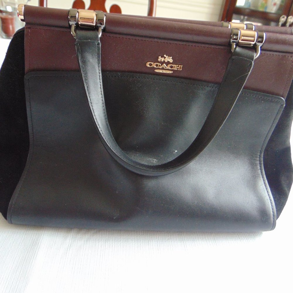 black purse with brown on opening on top
